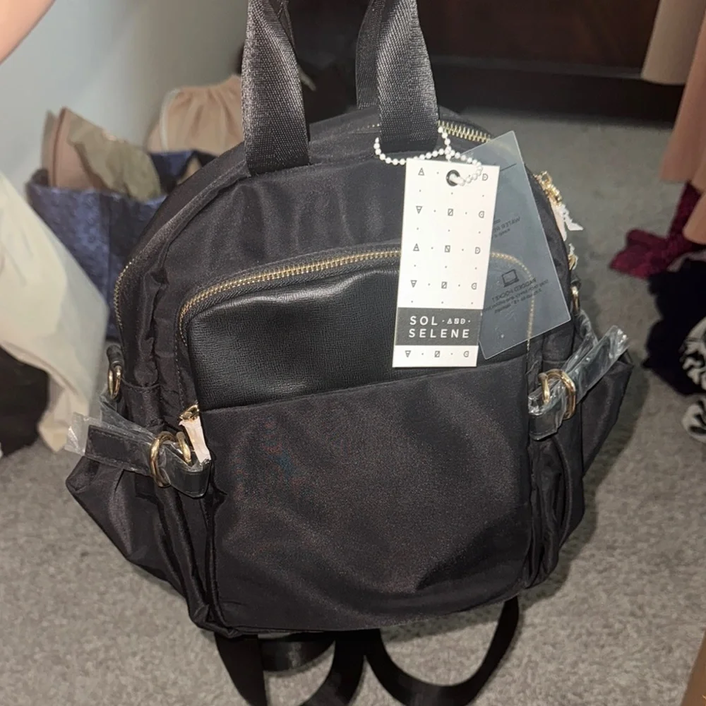 Sleek Black Backpack with Gold Zippers